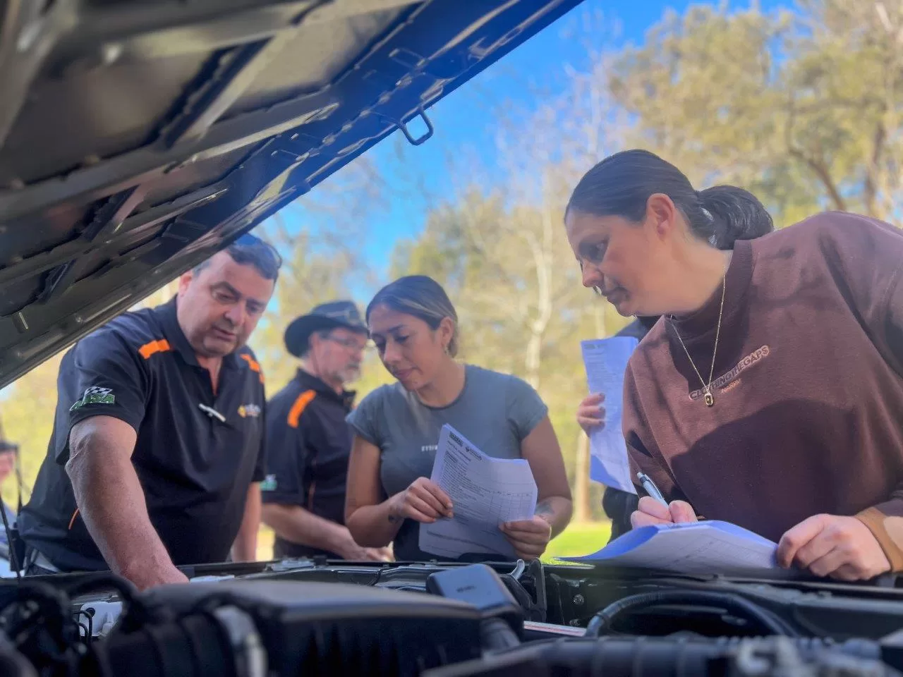 One of the PDA Team Members teaching trainees basic car mechanic